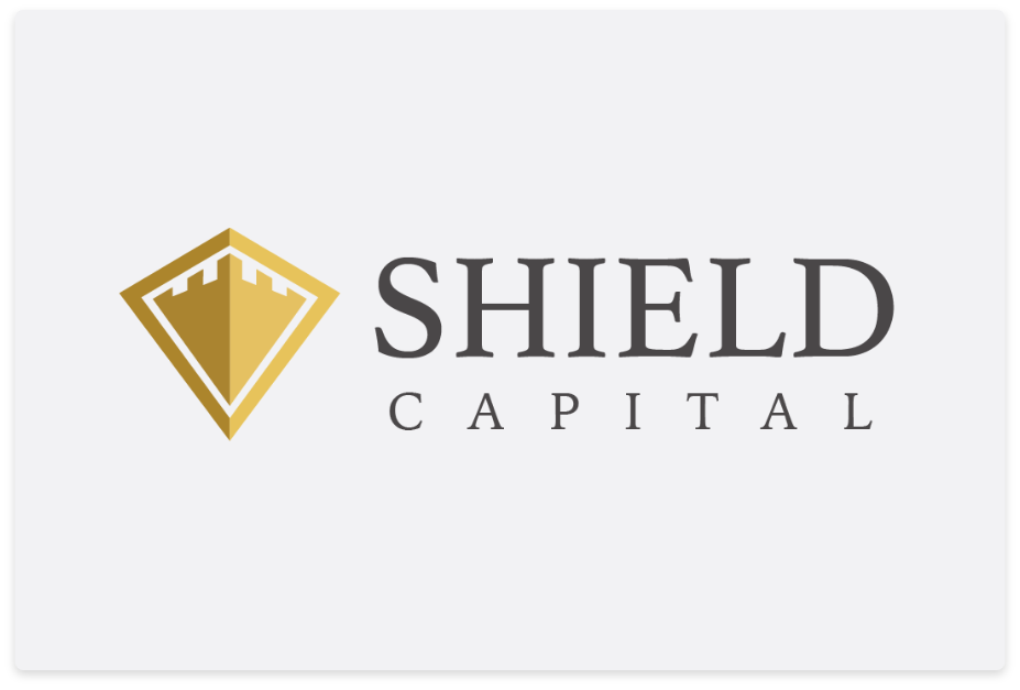 A professional logo design for "Shield Capital," featuring a gold shield emblem with a castle-inspired design and elegant serif typography in black. The logo conveys strength, security, and financial stability.